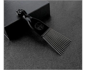 Detail of professional hair pick with black fist handle and silver metal teeth
