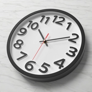 Modern 12-inch wall clock with 3D black Arabic numerals on a white dial and black frame