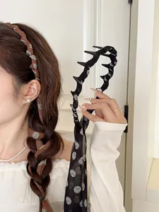 Close-up of retro brown polka dot chiffon scrunchie with long ribbons for hair styling