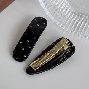 Acetate hair clips set with black rhinestone rectangle and marble teardrop duckbill designs