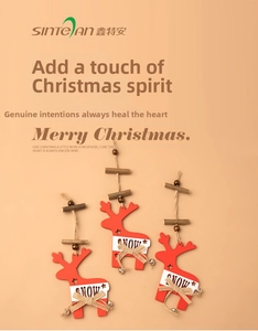 Detailed view of red wooden reindeer ornaments with bells, snow text and rustic burlap bows