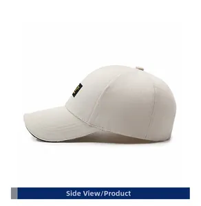 Side view of beige cotton baseball cap with embroidered patch and curved brim