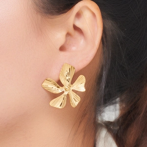 Statement gold five-petal flower stud earring with textured metal petals and beaded center