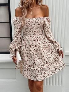 Detail view of floral dress featuring ruffled hemline and elasticated sleeve cuffs