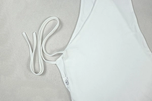 Detailed view of white halter top stitching and high-elastic fabric texture in size S