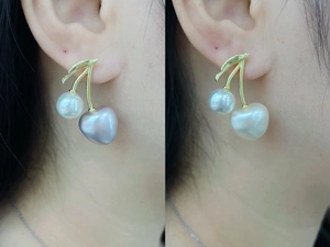 Detailed view of cherry pearl earrings with golden leaf stems and mixed colored pearls