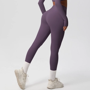 Detail of high-waisted dark purple yoga set showing seamless compression fit and lifting effect