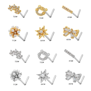 Multiple L-shaped nose studs in gold and silver with star and bow designs