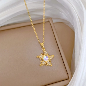 Close-up of a luxury gold starfish necklace with colorful crystal and pavé rhinestones