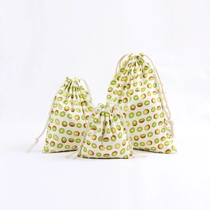 Three-piece linen drawstring storage bags with green kiwi fruit print on white background