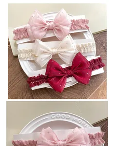 Detailed view of three lace baby headbands with large glittery tulle bows on a ceramic plate