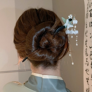 Detail of vintage lily of valley hair pin with white pearls and long metal tassels