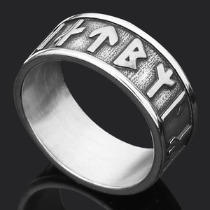 Macro view of Nordic runes and skull engraving on vintage silver stainless steel ring