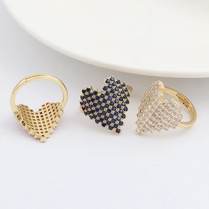Detail of pixel heart rings showing intricate gold mesh back and micro-pave crystals