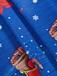 Macro shot of blue Christmas tablecloth fabric with ribbed texture and festive patterns