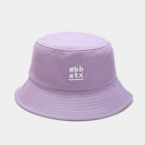 Close-up of lavender cotton bucket hat featuring #bb atx white embroidered text detail
