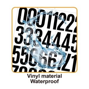 Close-up of waterproof vinyl number stickers with water splashes showing durability
