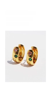 Detail of vintage gold hoops featuring pink star and colorful inlaid zircon stones