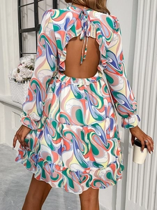 Elegant backless long sleeve mini dress featuring abstract print and tiered ruffle hem