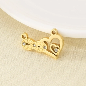 Detailed macro view of an 18K gold-plated infinity heart charm with sparkling rhinestones