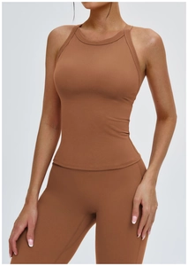 Detail of cross-back yoga vest and leggings set in caramel brown matte finish