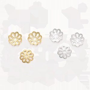 Macro detail of gold and silver hollow flower bead caps for DIY jewelry making