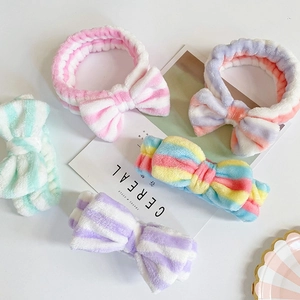 Macro detail of various colorful striped coral fleece bow headbands for face washing