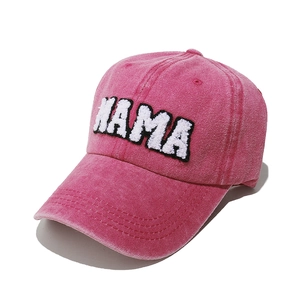 Close-up of pink washed cotton baseball cap with white MAMA towel embroidery detail