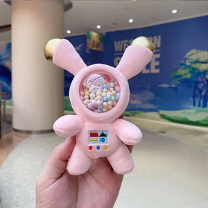 Detailed view of pink astronaut bunny plush keychain with gold ears and bead-filled mask