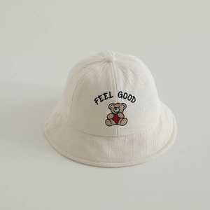 Close-up of bear embroidery and FEEL GOOD text on waffle texture kids bucket hat