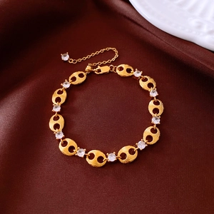 Detail of gold adjustable chain bracelet with cubic zirconia stones on satin