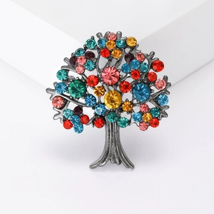Elegant grey alloy Tree of Life brooch with colorful crystals on a white background