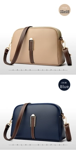 Detail view of khaki and blue textured leather shell bags with gold hardware and stitching