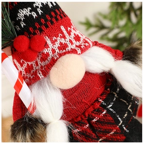 Close-up of a Christmas gnome featuring red knit hat and plush white beard details