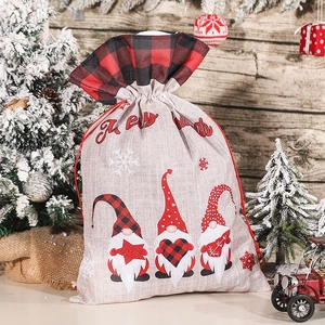 Linen Christmas gift bag featuring three Swedish gnomes and red drawstring closure