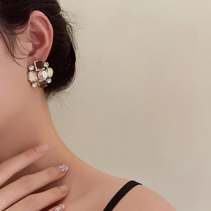 Vintage floral pearl earrings with black onyx and sparkling crystals on model