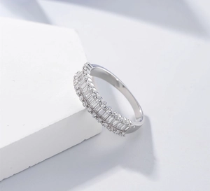 Detail of S925 silver half-eternity ring with baguette-cut and round cubic zirconia