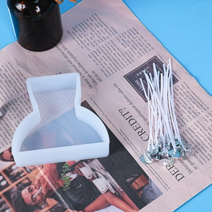 DIY candle kit featuring a white silicone figure mold and 20 cotton wicks with metal bases