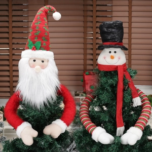 Christmas tree toppers featuring Santa and snowman dolls with festive knit decorations