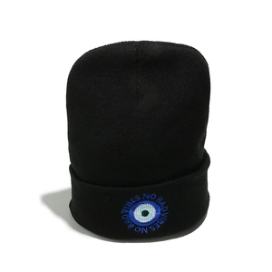 Detail of No Bad Vibes embroidery and Evil Eye symbol on black knitted beanie hat