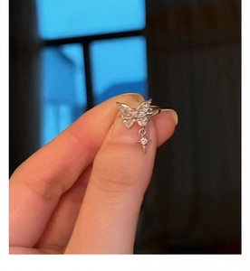 Silver butterfly ear cuff with dangling star charm and sparkling cubic zirconia