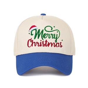 Close-up of Merry Christmas embroidery on a beige and blue five-panel trucker hat