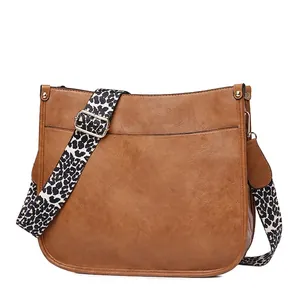 Brown faux leather tote shoulder bag with adjustable leopard print strap and gold hardware