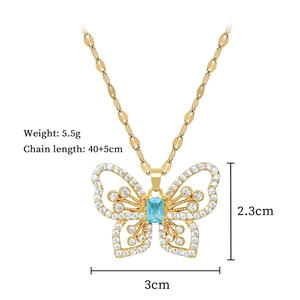 Macro shot of gold butterfly necklace with blue stone and crystals, sized 3cm x 2.3cm