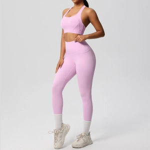 Detail of pink yoga set showing functional side pocket on high-waist leggings