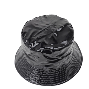 Detail of glossy black patent leather bucket hat showing high-shine finish and stitched brim