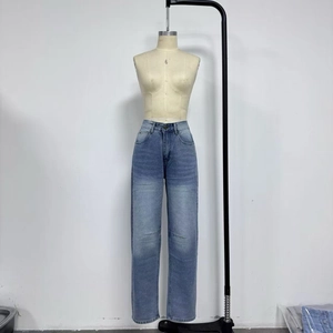 Detail shot of light blue washed denim jeans with distressed vintage fading on the thighs