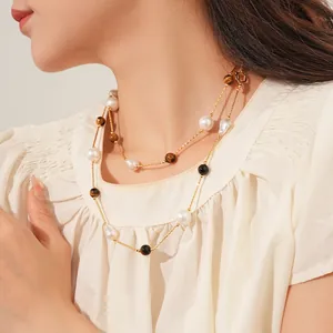 Elegant double-layered tiger eye and pearl necklace with golden chains on model
