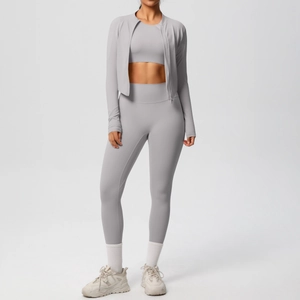 Detailed view of light gray three-piece women activewear set with jacket and leggings