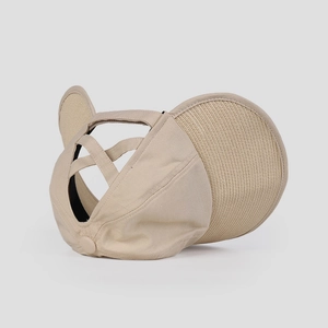 Detail of cross elastic straps on a beige linen sun visor for ponytail hairstyles